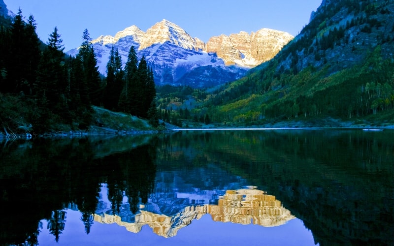 The Maroon Bells are reflected off a mountian lake