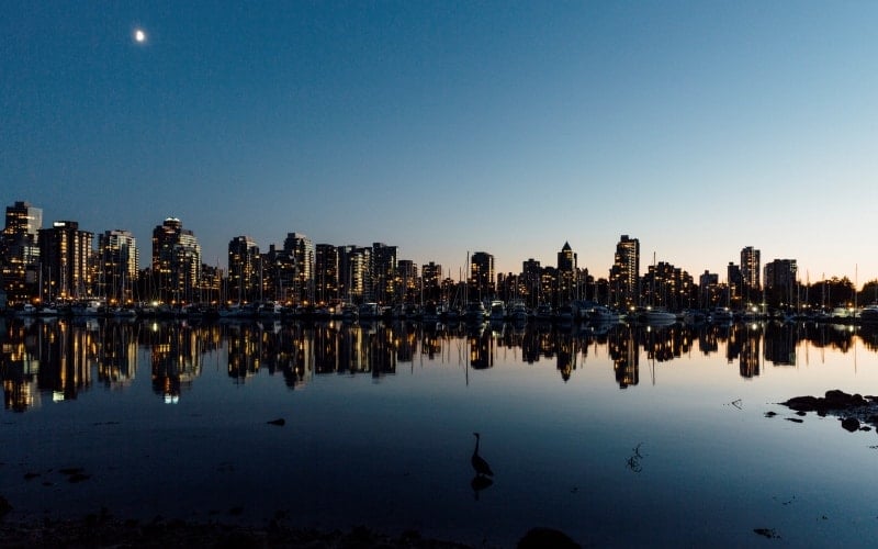 A view back at Vancouver at night across Vancouver Harbour. Vancouver, Canada // Vancouver has a lot of high rise buildings and new sky scrapers - at night the light up giving a real sense of the cities cosmopolitan side.