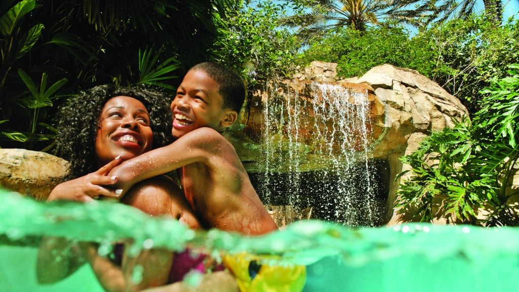 Visit Florida Families2018_Reunion_Lazy River Mom and Son by Waterfall 2