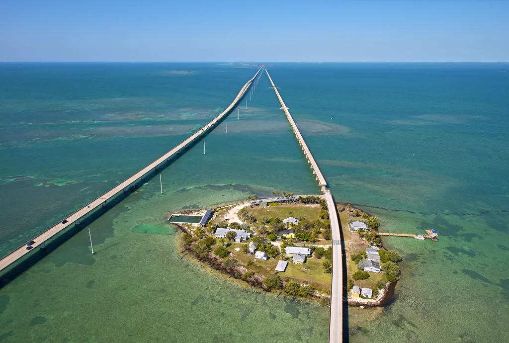 Pigeon Key, the one-time base camp for the workers that constructed Henry Flagler's Florida Keys Over-Sea Railroad is both an educational center and a visitor attraction featuring a small museum that pays homage to railroad that opened in January 1912 and ceased operations in September 1935. Flaglers' original Seven Mile Bridge bisects the island on the right, while today's modern day bridge is on the left. Photo by Andy Newman/Florida Keys News Bureau)