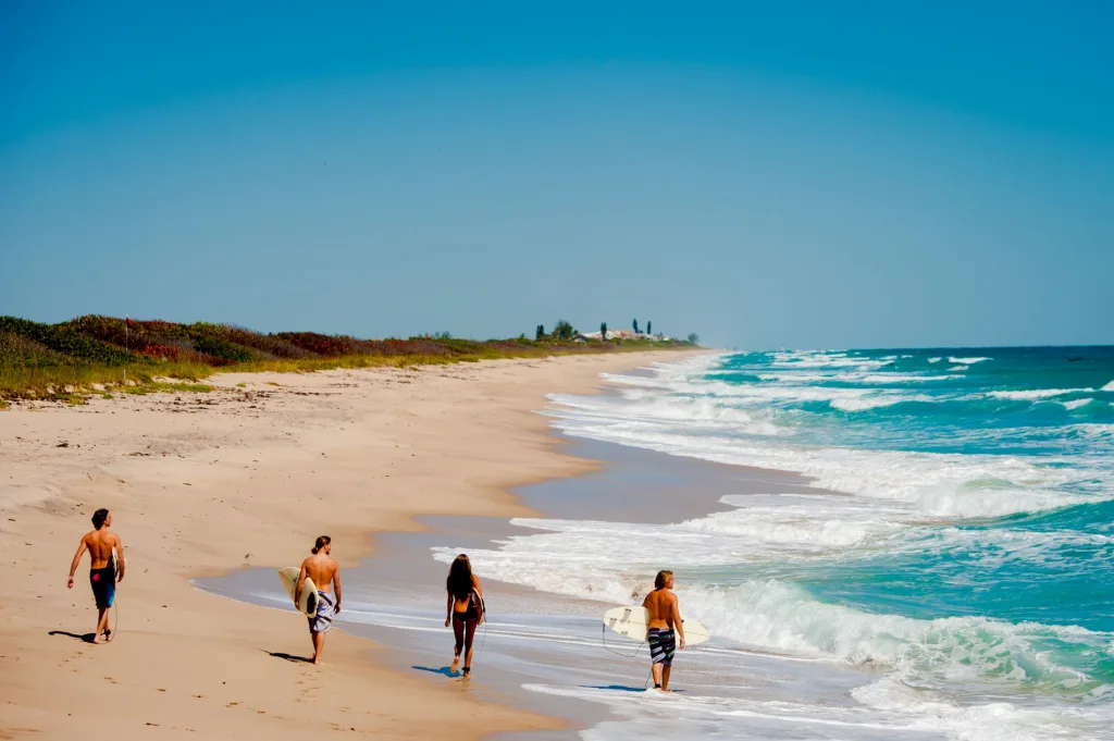 Florida's Space Coast Beach surfers walking